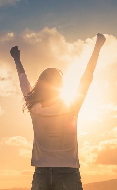 woman with hands in air